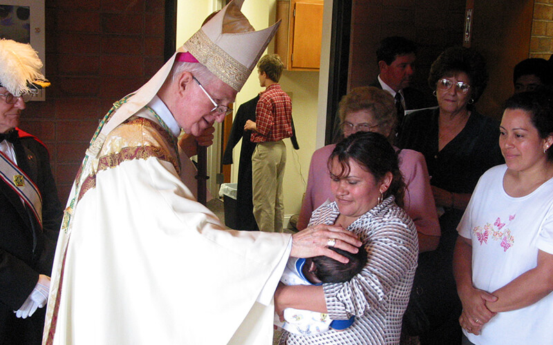 Bishop Curlin blessing child