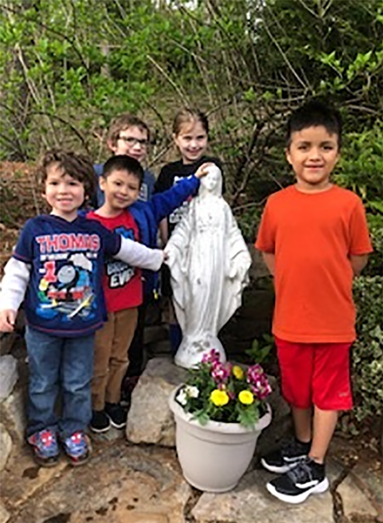 Young Sylva parishioners clean up Marian grotto 2
